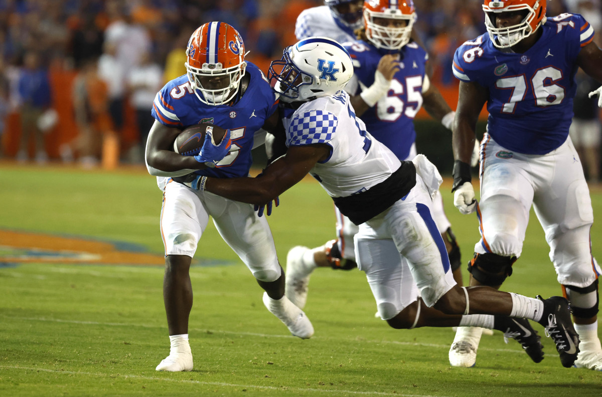 Sep 10, 2022; Gainesville, Florida, USA; Kentucky Wildcats linebacker J.J. Weaver (13) tackles Florida Gators running back Nay'Quan Wright (5) during the second half at Ben Hill Griffin Stadium. Mandatory Credit: Kim Klement-USA TODAY Sports