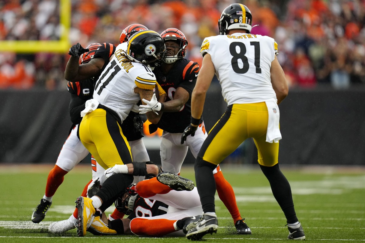 Sep 11, 2022; Cincinnati, Ohio, USA; Cincinnati Bengals cornerback Eli Apple (20) and defensive end Sam Hubbard (94) tackle Pittsburgh Steelers wide receiver Chase Claypool (11) during the first quarter of a Week 1 NFL football game at Paycor Stadium. Mandatory Credit: Sam Greene-USA TODAY Sports