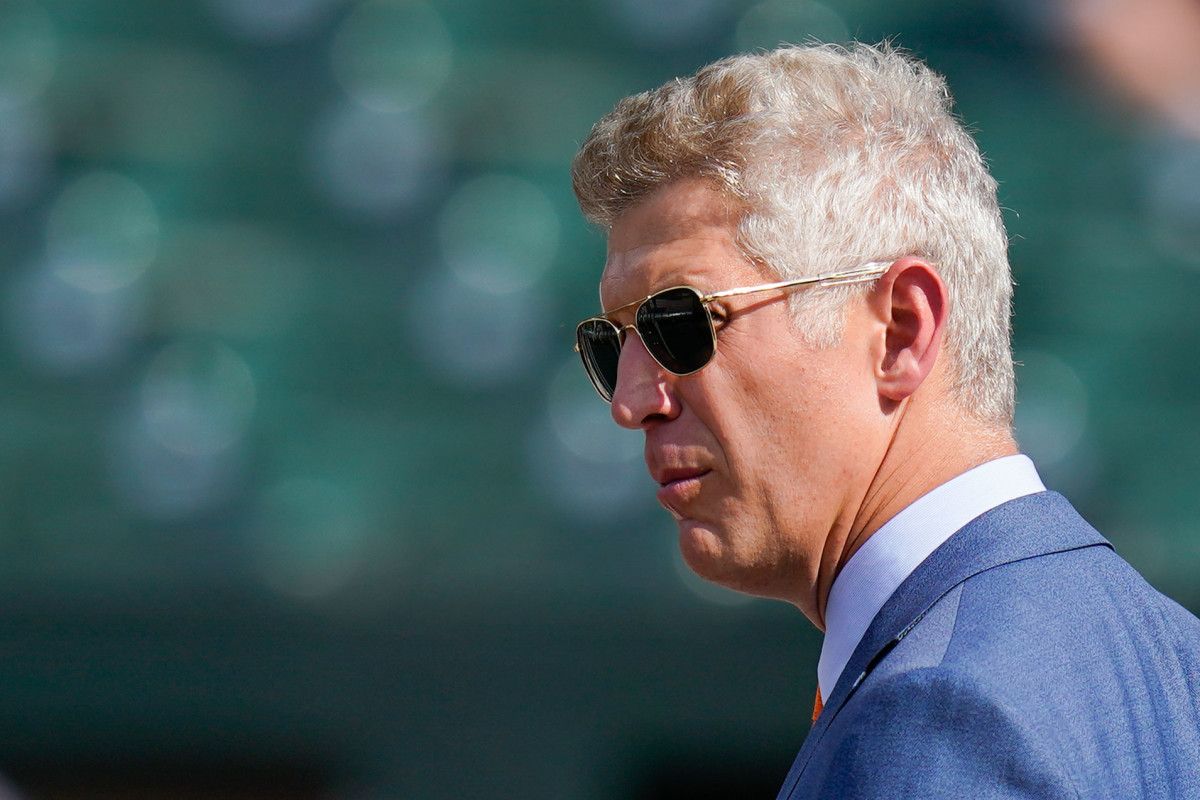 Orioles general manager Mike Elias looking off in the distance while wearing sunglasses.
