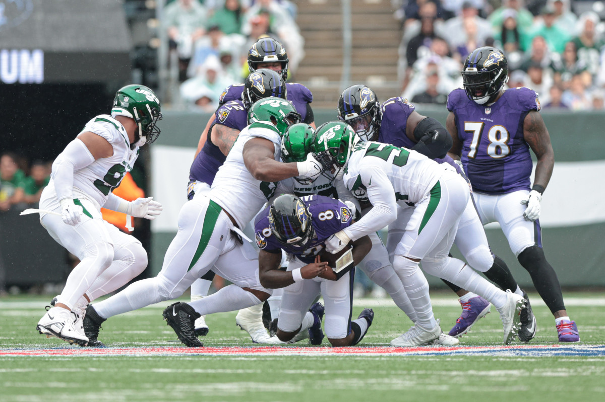 Sep 11, 2022; East Rutherford, New Jersey, USA; Baltimore Ravens quarterback Lamar Jackson (8) is sacked by New York Jets defensive end Carl Lawson (58) during the first half at MetLife Stadium. Mandatory Credit: Vincent Carchietta-USA TODAY Sports