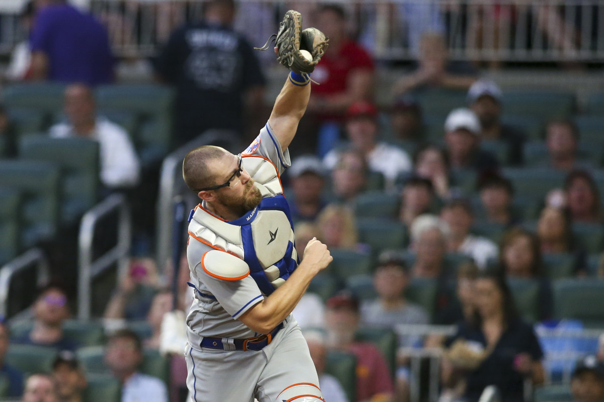 Mets catcher Patrick Mazeika catches a foul ball behind home plate.