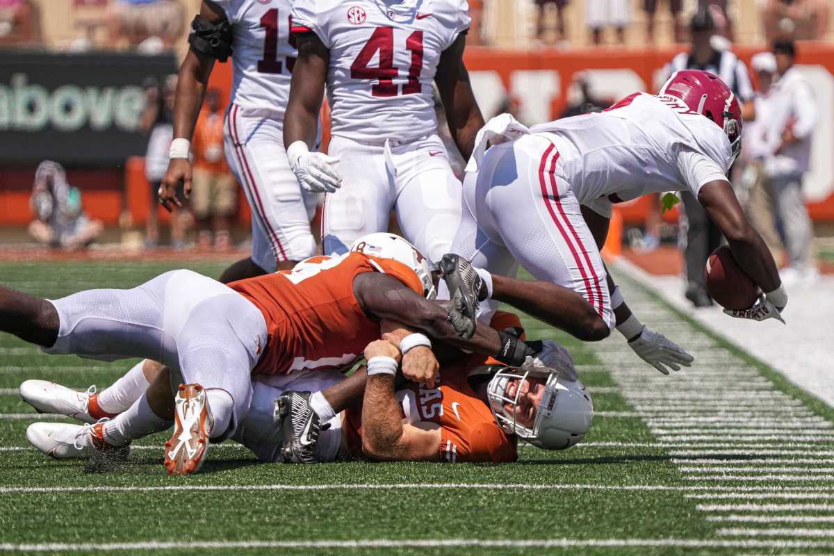 Alabama defensive back Kool-Aid McKinstry (1) is tackled by Texas defensive specialist Zach edwards (29) and edge Ovie Oghoufo (18) during the game at Royal Memorial Stadium on Sep. 10, 2022. Aem Texas Vs Alabama 40