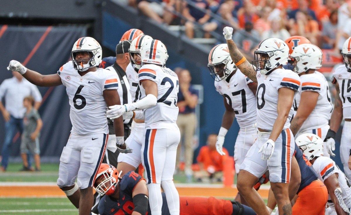The Virginia Cavaliers defense reacts to making a stop against the Illinois Fighting Illini.