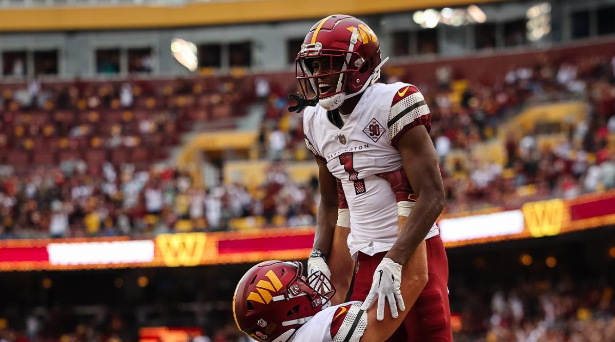 Sep 11, 2022; Landover, Maryland, USA; Washington Commanders wide receiver Jahan Dotson (1) celebrates with tight end John Bates (87) after catching the game winning touchdown against the Jacksonville Jaguars during the second half at FedExField.