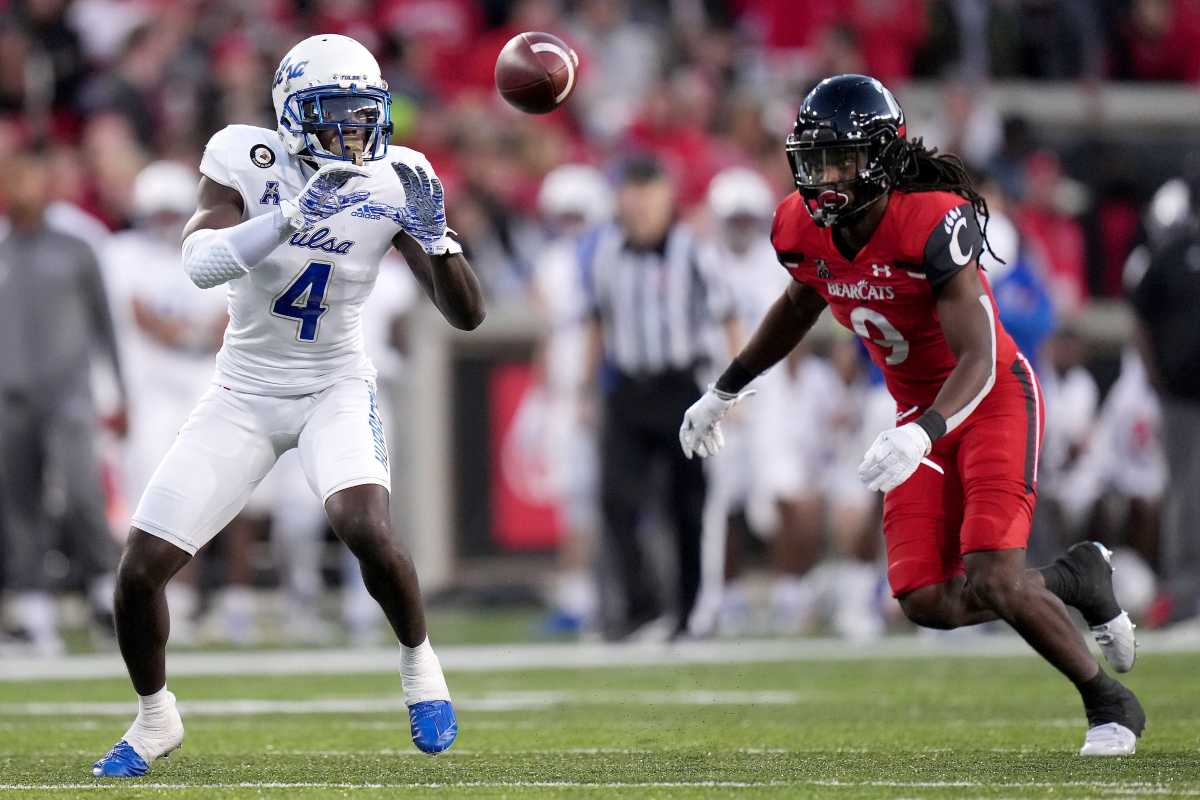 Tulsa receiver Josh Johnson (4) catches a pass as Cincinnati cornerback Arquon Bush (9) defends in the fourth quarter of the Bearcats' 28-20 win on Nov. 6. Syndication The Enquirer