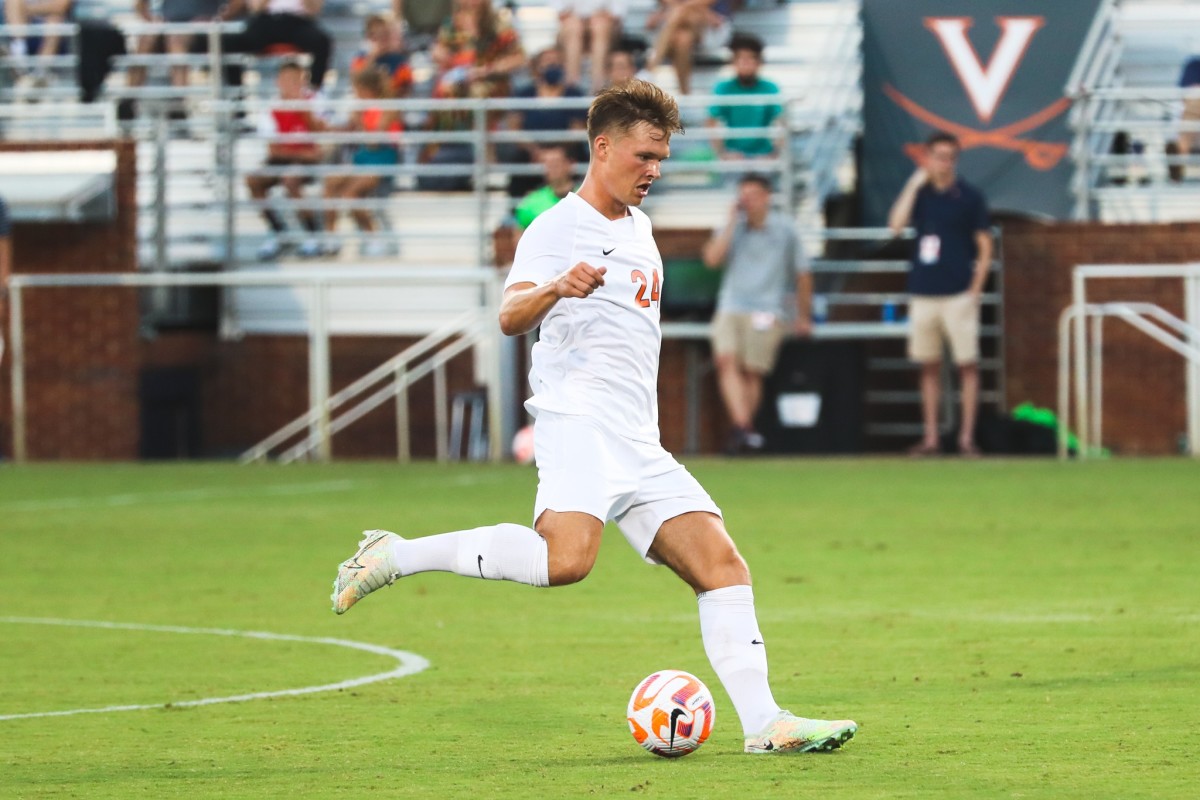 Virginia men's soccer junior midfielder Axel Ahlander passes the ball.