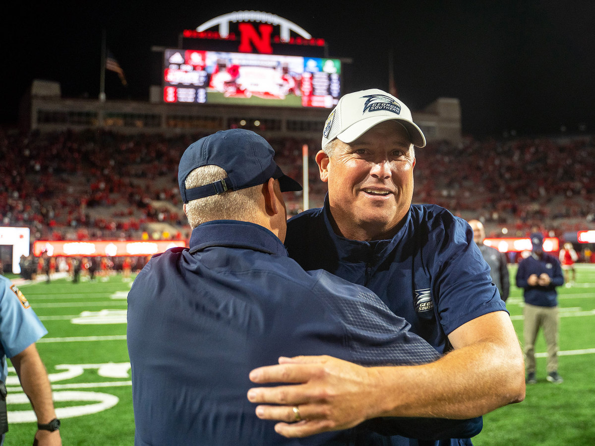 Clay Helton hugs an assistant after beating Nebraska