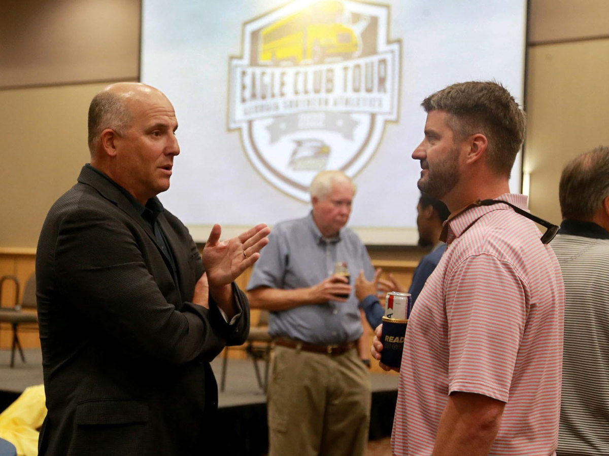 Clay Helton speaks with Richmond Hill coach Matt LeZotte