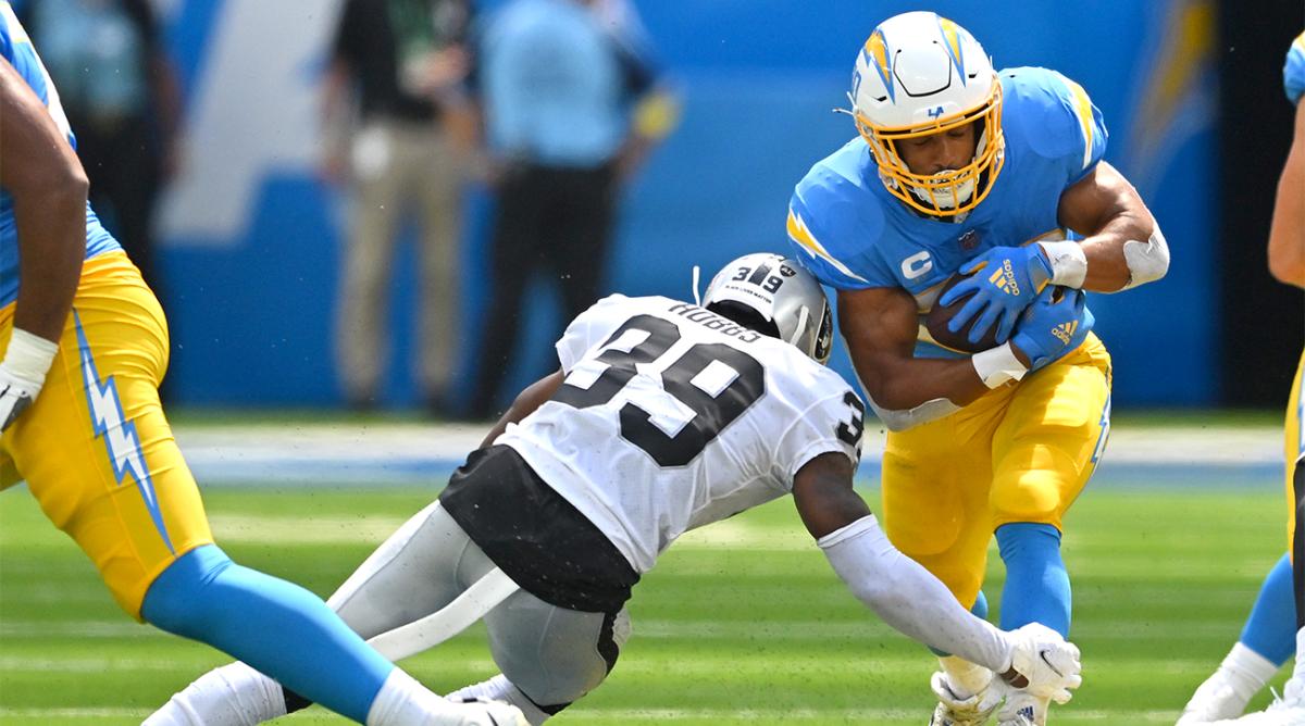 Sep 11, 2022; Inglewood, California, USA; Los Angeles Chargers running back Austin Ekeler (30) is stopped by Las Vegas Raiders cornerback Nate Hobbs (39) after a short gain in the first quarter at SoFi Stadium.
