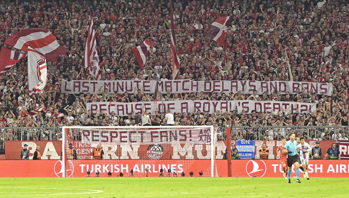 Bayern Munich fans pictured displaying a banner during a Champions League game against Barcelona. The banner reads: "Last minute match delays and bans because of a royal's death?! Respect fans!"