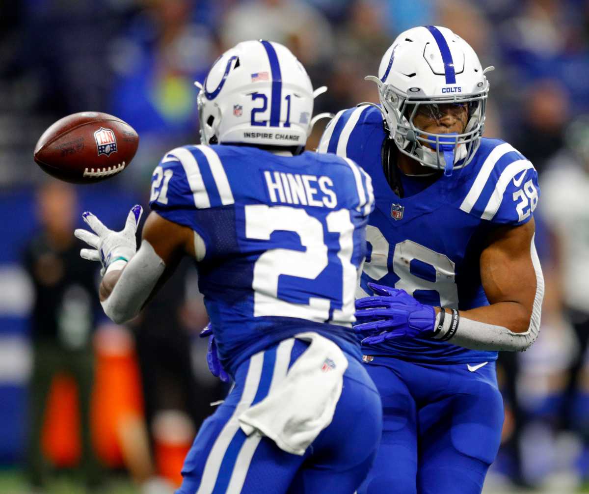 Indianapolis Colts running back Jonathan Taylor (28) tosses the ball to Indianapolis Colts running back Nyheim Hines (21) on Thursday, Nov. 4, 2021, during a game against the New York Jets at Lucas Oil Stadium in Indianapolis.