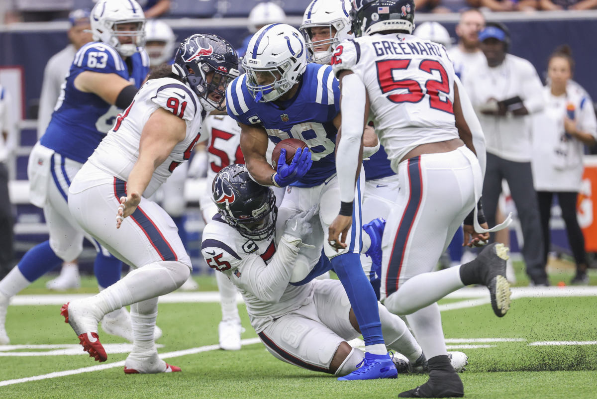 Sep 11, 2022; Houston, Texas, USA; Indianapolis Colts running back Jonathan Taylor (28) runs with the ball as Houston Texans defensive end Jerry Hughes (55) attempts to make a tackle during the first quarter at NRG Stadium.