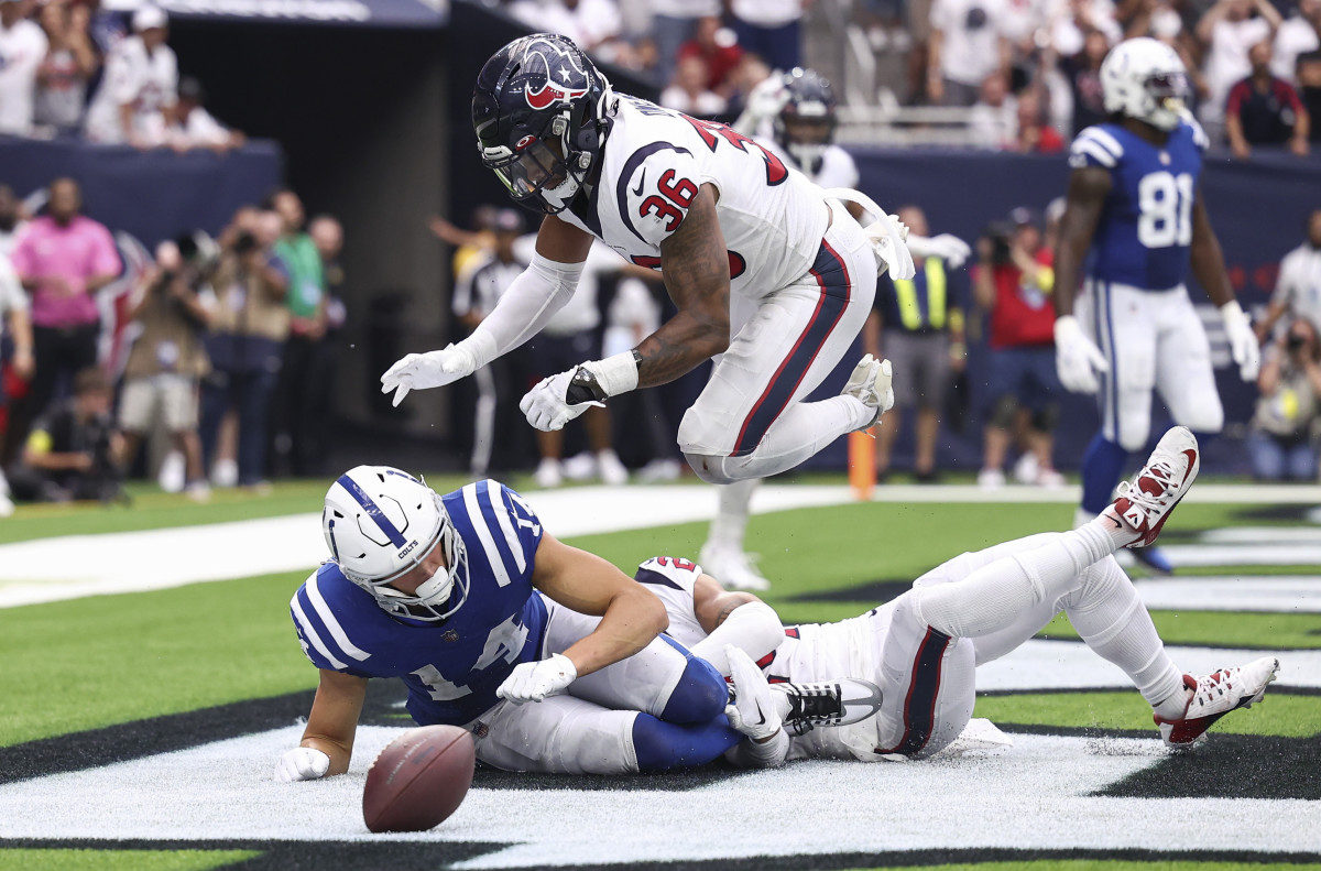 Sep 11, 2022; Houston, Texas, USA; Houston Texans safety Jonathan Owens (36) leaps over Indianapolis Colts wide receiver Alec Pierce (14) on a play during the fourth quarter at NRG Stadium. Mandatory Credit: Troy Taormina-USA TODAY Sports