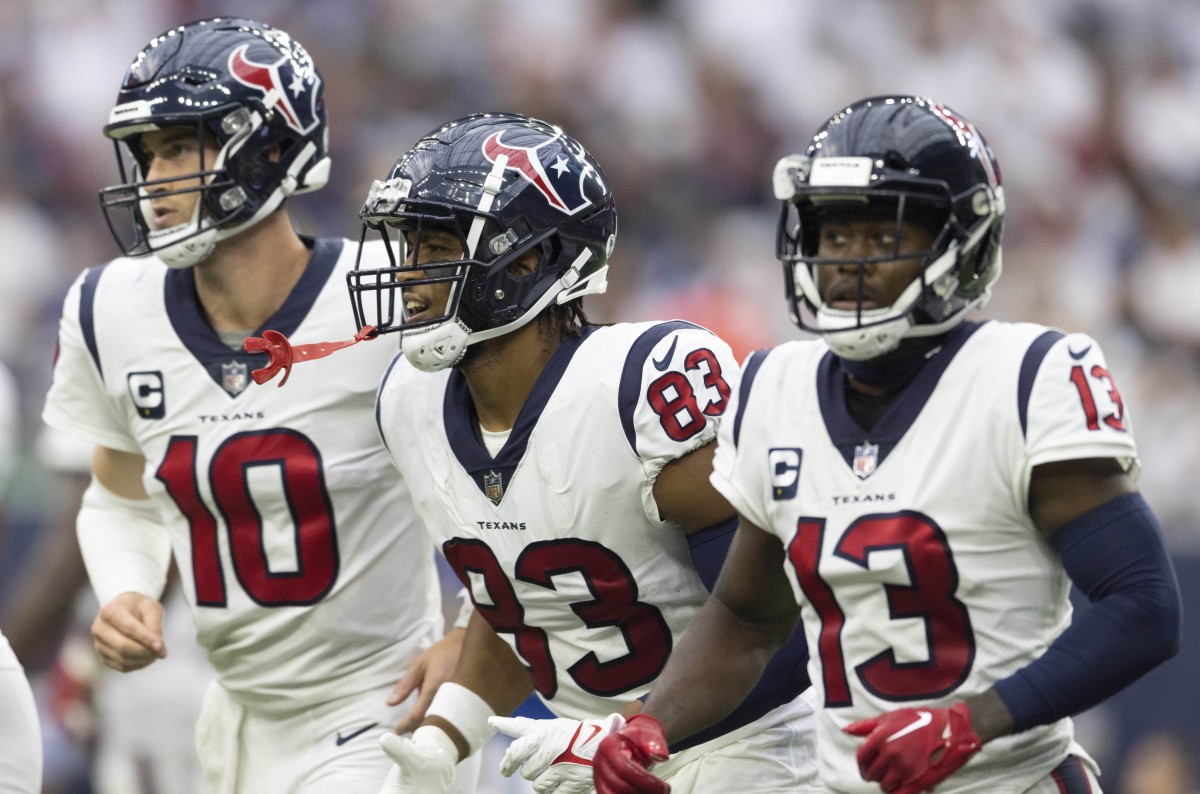 Houston Texans quarterback Davis Mills (10) and wide receiver Brandin Cooks (13) celebrate tight end O.J. Howard (83) touchdown against the Indianapolis Colts in the third quarter at NRG Stadium.