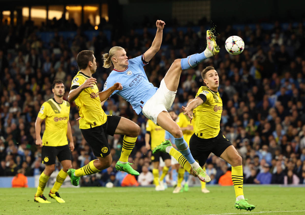 Erling Haaland pictured scoring a spectacular goal for Manchester City against Borussia Dortmund in September 2022