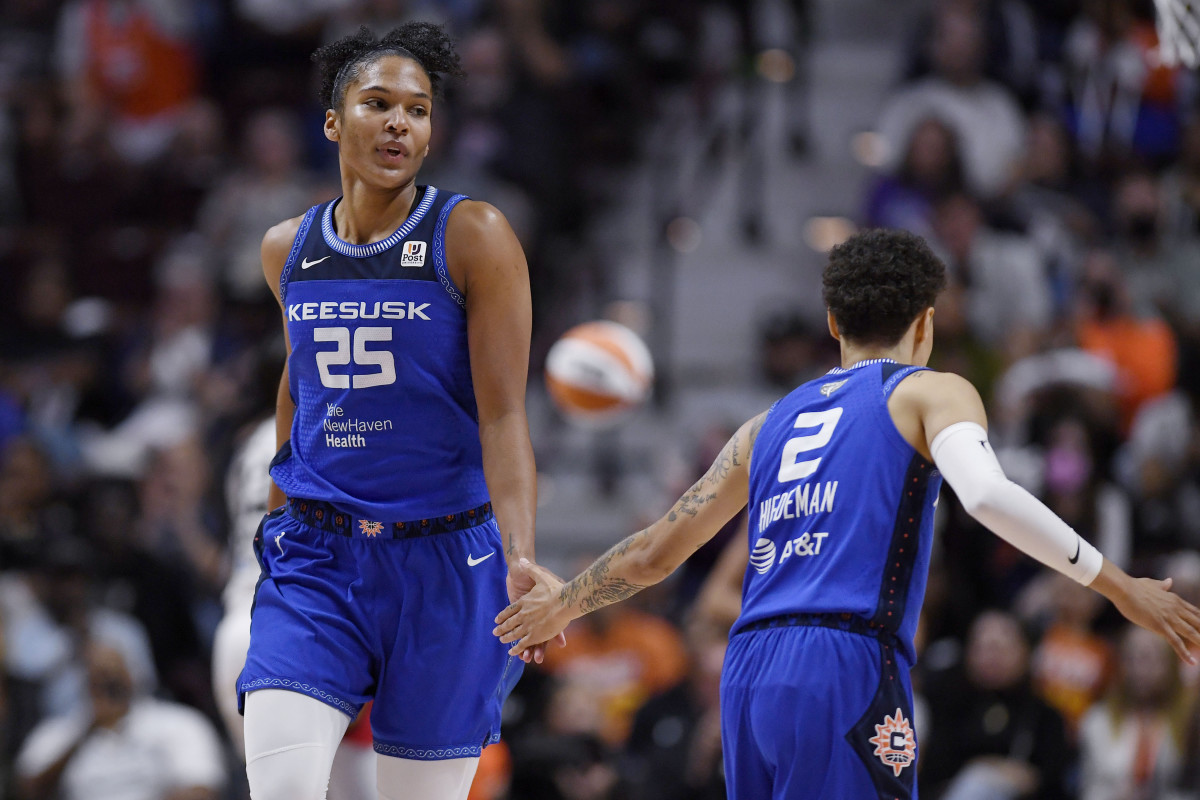 Connecticut Sun's Alyssa Thomas slaps hands with Natisha Hiedeman, right, during the second half of Game 3 of the basketball team's WNBA Finals against the Las Vegas Aces, Thursday, Sept. 15, 2022, in Uncasville, Conn.