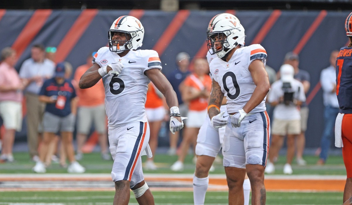 Virginia linebacker Nick Jackson and safety Antonio Clary celebrate after making a stop against Illinois.