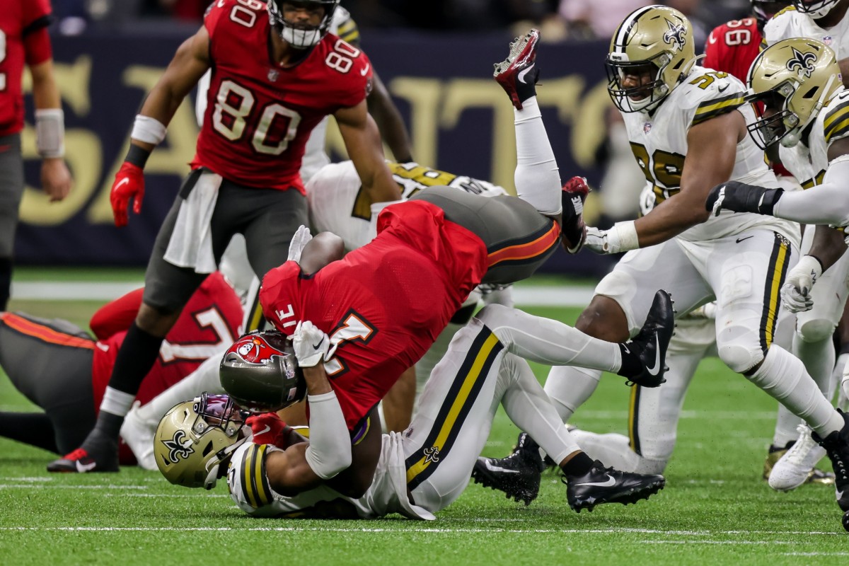Oct 31, 2021; The New Orleans Saints swarm Tampa Bay Buccaneers running back Leonard Fournette (7). Mandatory Credit: Stephen Lew-USA TODAY Sports