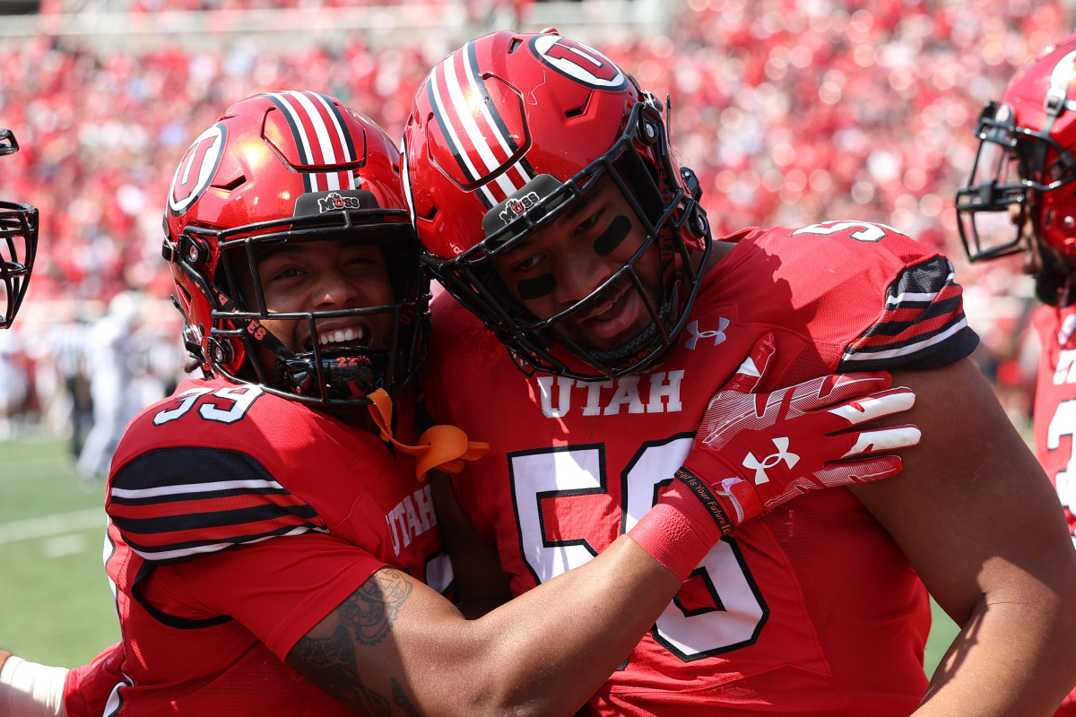 Utah Utes defensive tackle Junior Tafuna (58) celebrates an interception with safety Jadon Pearson (39) in the second quarter against the Southern Utah Thunderbirds at Rice-Eccles Stadium.