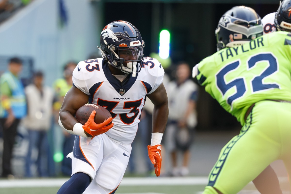 Denver Broncos running back Javonte Williams (33) rushes against the Seattle Seahawks during the first quarter at Lumen Field.