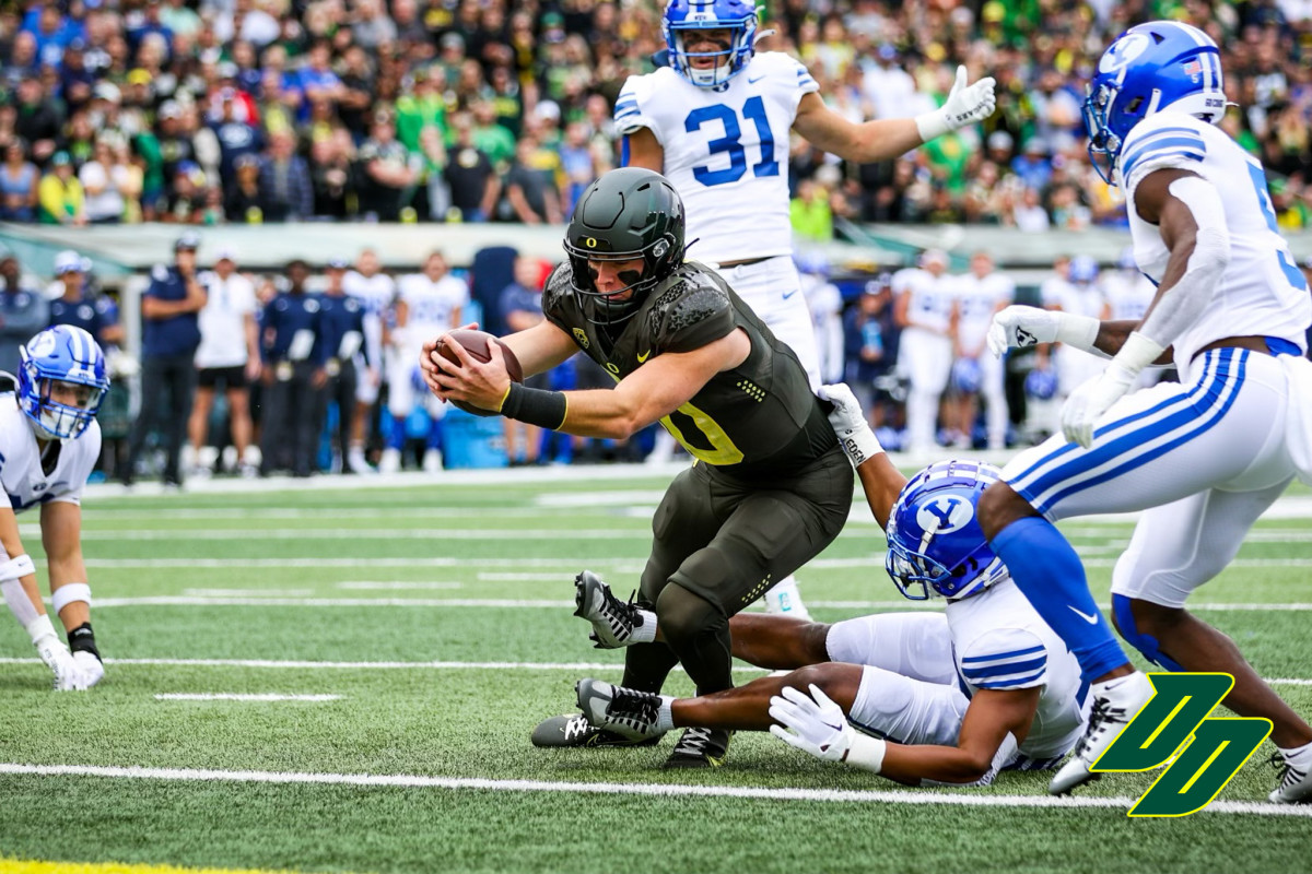 Oregon Ducks quarterback Bo Nix extends for a touchdown against the BYU Cougars at Autzen Stadium in Eugene, Oregon. 