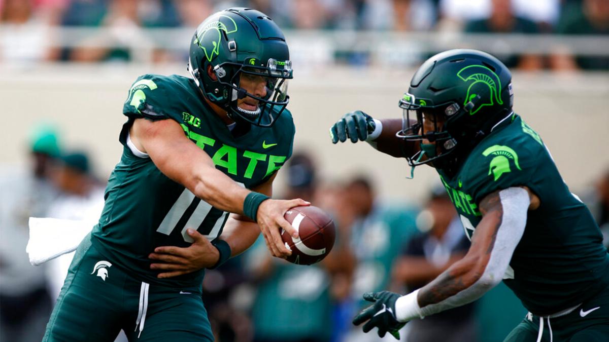Michigan State quarterback Payton Thorne, left, hands off to running back Jalen Berger during the second quarter of an NCAA college football game against Akron, Saturday, Sept. 10, 2022, in East Lansing, Mich.