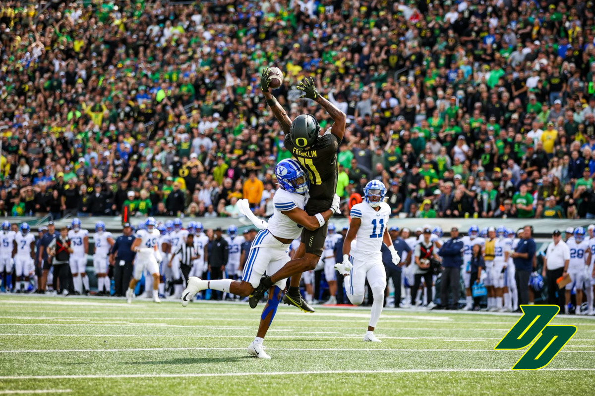 Oregon wide receiver Troy Franklin hauls in a deep pass from Bo Nix during a game against the BYU Cougars at Autzen Stadium.