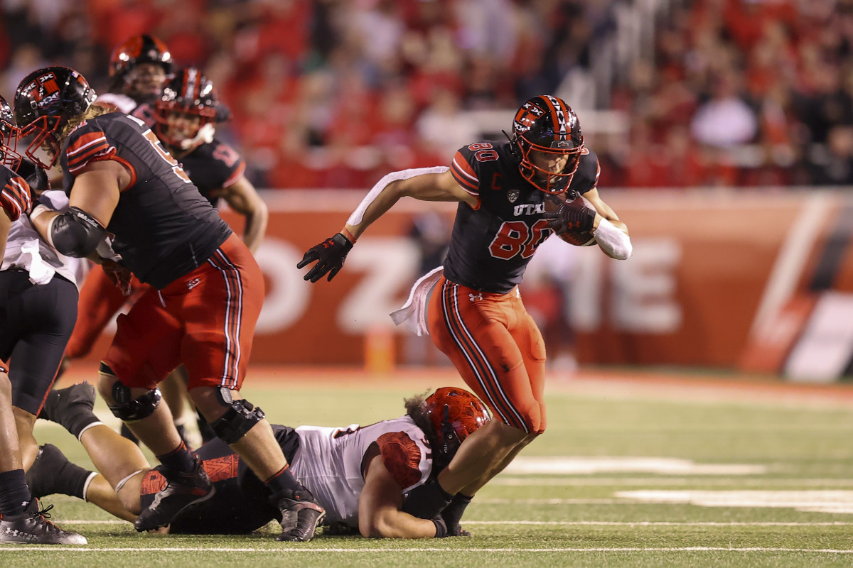 Utah Utes tight end Brant Kuithe (80) catches a pass and is brought down by San Diego State Aztecs defensive lineman Justus Tavai (91) in the second quarter at Rice-Eccles Stadium.