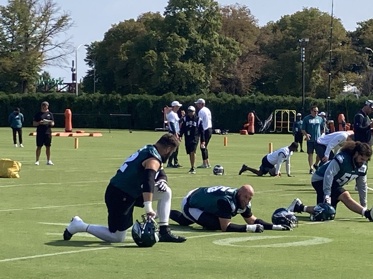 Jason Kelce, Lane Johson, and Isaac Seumalo (from left to right) get loose prior to a practice in preparation for the home opener vs. the Vikings