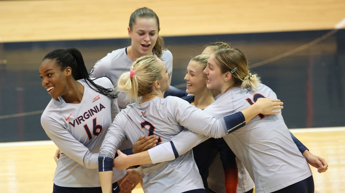 The Virginia volleyball team celebrates after scoring a point against East Carolina.