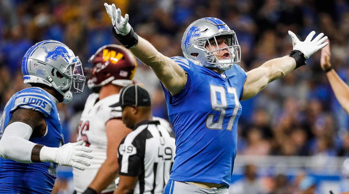 Lions defensive end Aidan Hutchinson celebrates a sack against Commanders quarterback Carson Wentz.