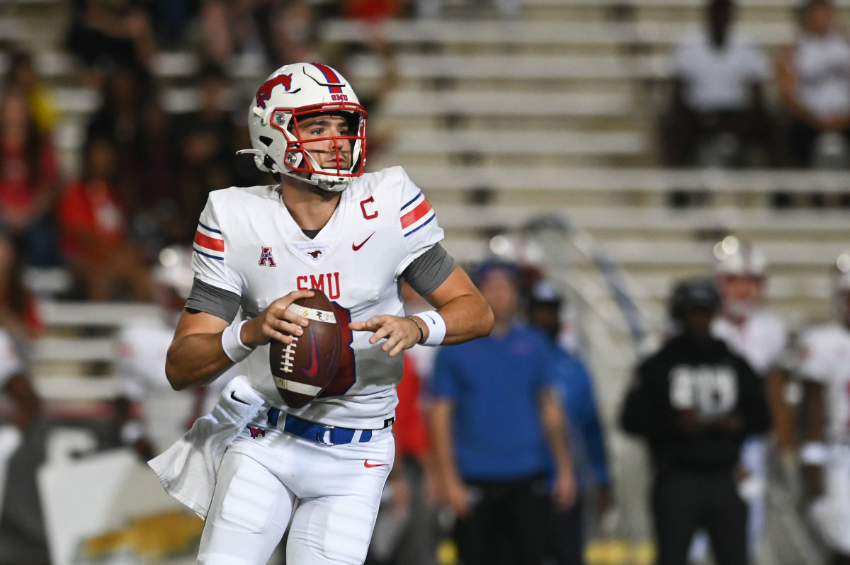 Southern Methodist Mustangs quarterback Tanner Mordecai (8) rolls out to pass during the first quarter against the Maryland Terrapins at Capital One Field at Maryland Stadium.