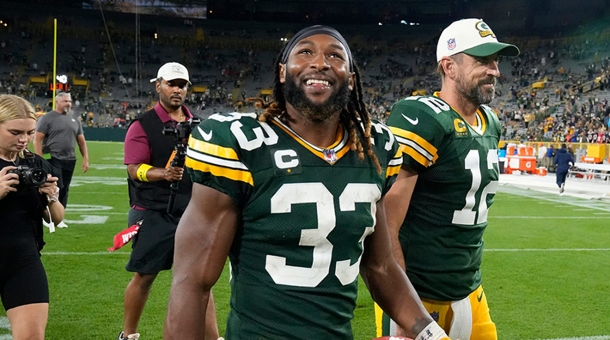Packers running back Aaron Jones (33) and quarterback Aaron Rodgers (12) walk of the after their win against the Bears.