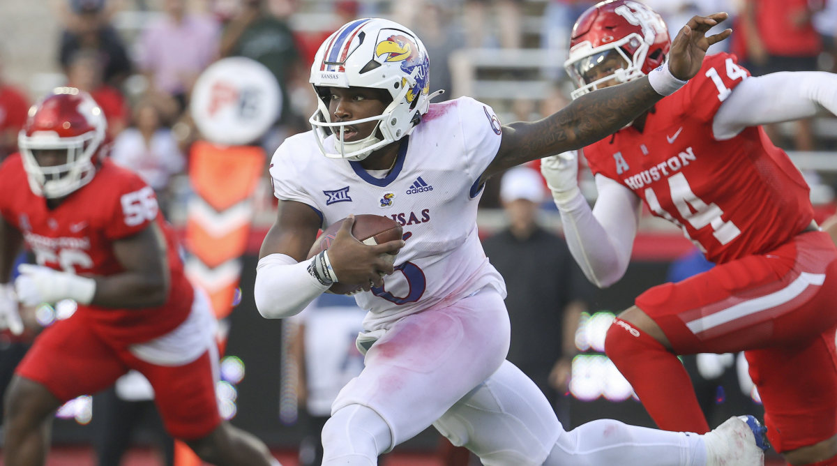 Kansas Jayhawks quarterback Jalon Daniels (6) runs with the ball for a first down during the second quarter against the Houston Cougars at TDECU Stadium.