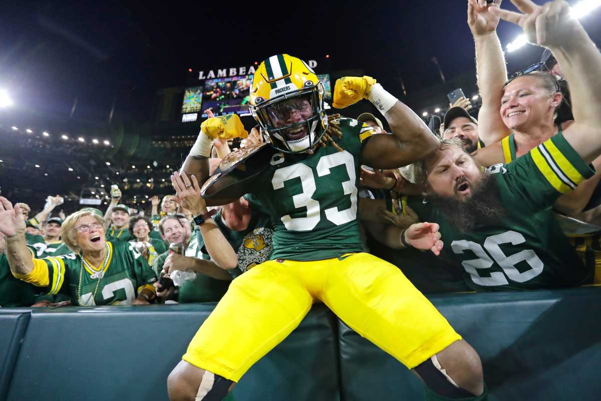 Green Bay Packers running back Aaron Jones (33) celebrates with fans after scoring a touchdown against the Chicago Bears in the second quarter during their football game.