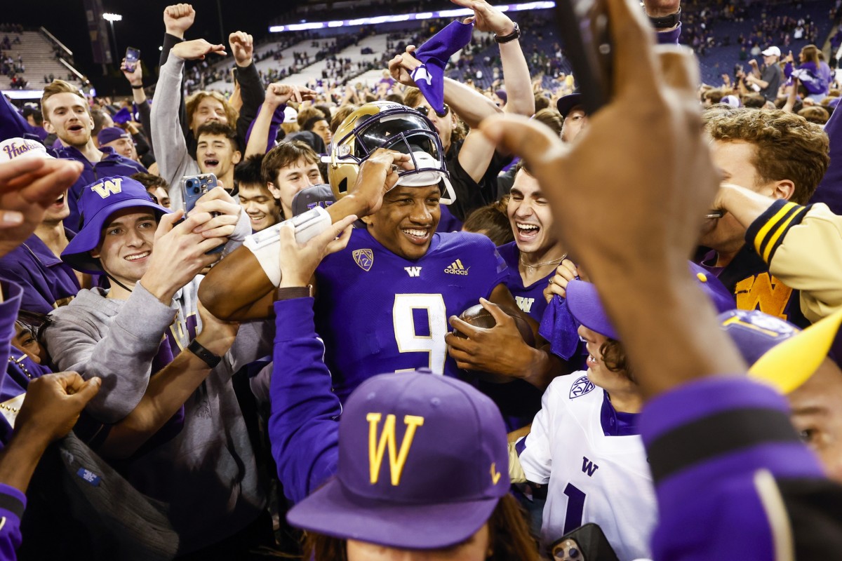 Washington Huskies quarterback Michael Penix Jr. (9) celebrates with fans following a 39-28 victory against the Michigan State Spartans at Alaska Airlines Field at Husky Stadium.