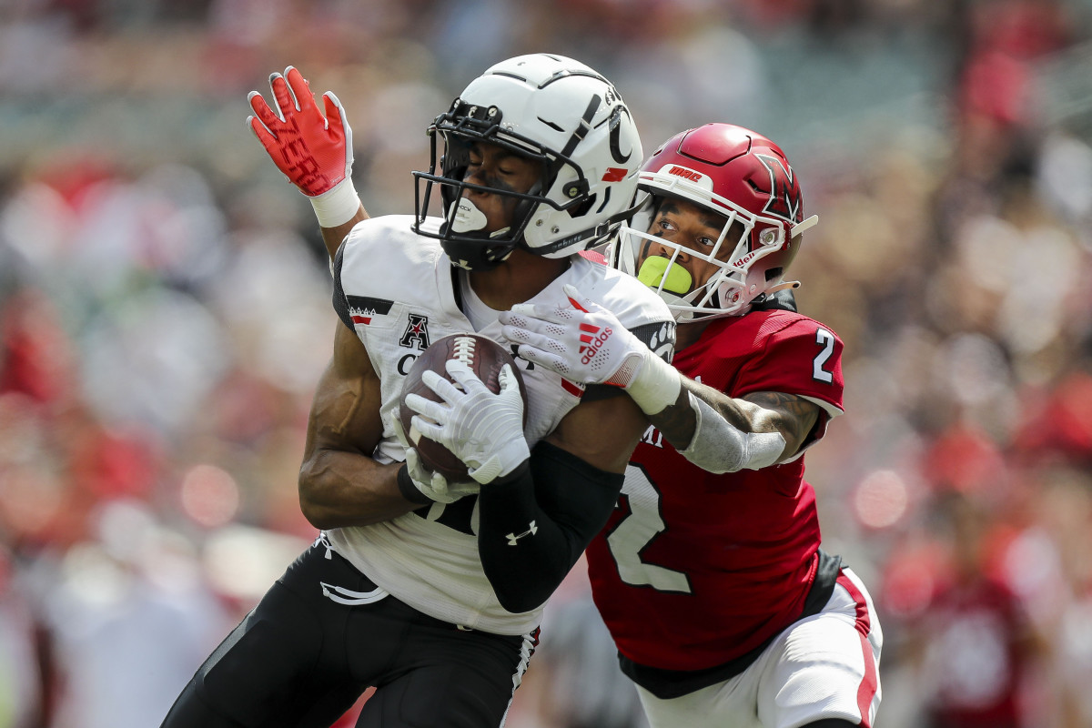 Sep 17, 2022; Cincinnati, Ohio, USA; Cincinnati Bearcats wide receiver Tyler Scott (21) catches a pass against Miami Redhawks defensive back Yahsyn McKee (2) in the second half at Paycor Stadium. Mandatory Credit: Katie Stratman-USA TODAY Sports