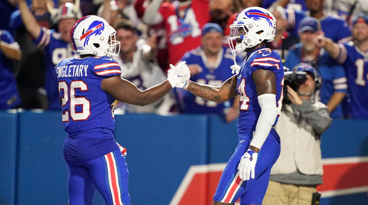 Sep 19, 2022; Orchard Park, New York, USA; Buffalo Bills wide receiver Stefon Diggs (14) congratulates running back Devin Singletary (26) after a touch down during the third quarter against the Tennessee Titans at Highmark Stadium.