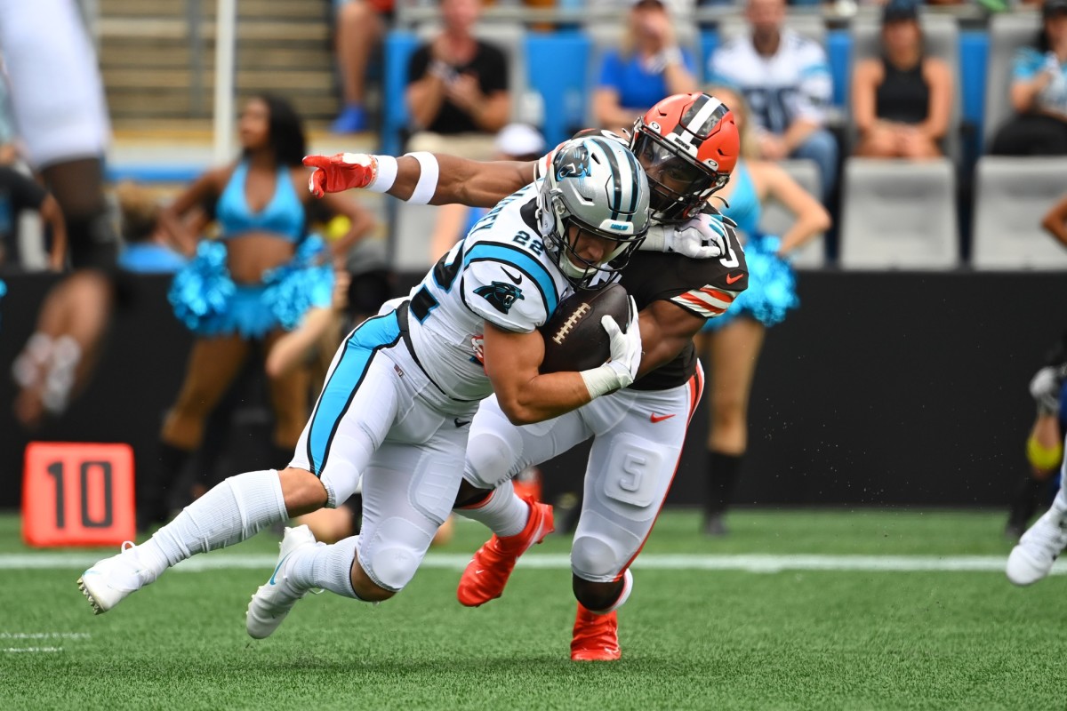 Sep 11, 2022; Charlotte, North Carolina, USA; Carolina Panthers running back Christian McCaffrey (22) is tackled by Cleveland Browns linebacker Anthony Walker Jr. (5) in the first quarter at Bank of America Stadium. Mandatory Credit: Bob Donnan-USA TODAY Sports