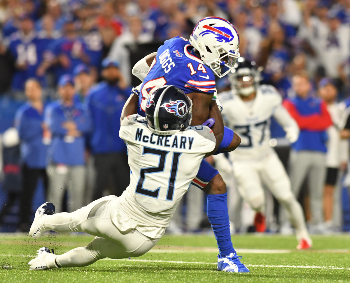 Sep 19, 2022; Orchard Park, New York, USA; Buffalo Bills wide receiver Stefon Diggs (14) is tackled by Tennessee Titans cornerback Roger McCreary (21) after a catch in the second quarter at Highmark Stadium. Mandatory Credit: Mark Konezny-USA TODAY Sports