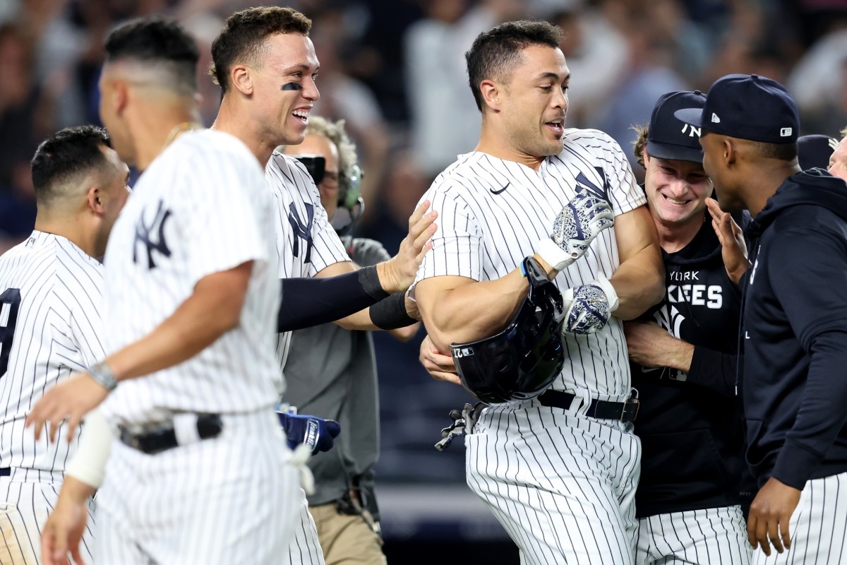 New York Yankees designated hitter Giancarlo Stanton (27) celebrates his walkoff grand slam against the Pittsburgh Pirates with right fielder Aaron Judge (99) and starting pitcher Gerrit Cole (45) at Yankee Stadium. (Brad Penner-USA TODAY Sports)
