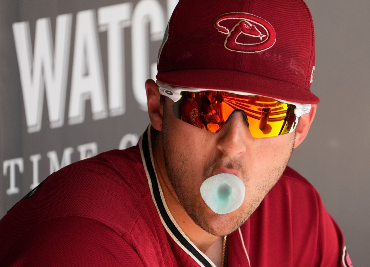 Dominic Canzone blows a bubble while watching a Spring Training Game