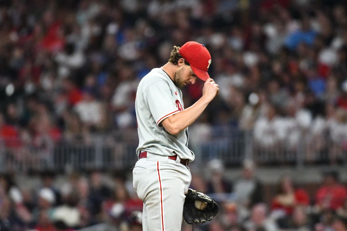 Aaron Nola adjusts his cap at Truist Park in Atlanta.
