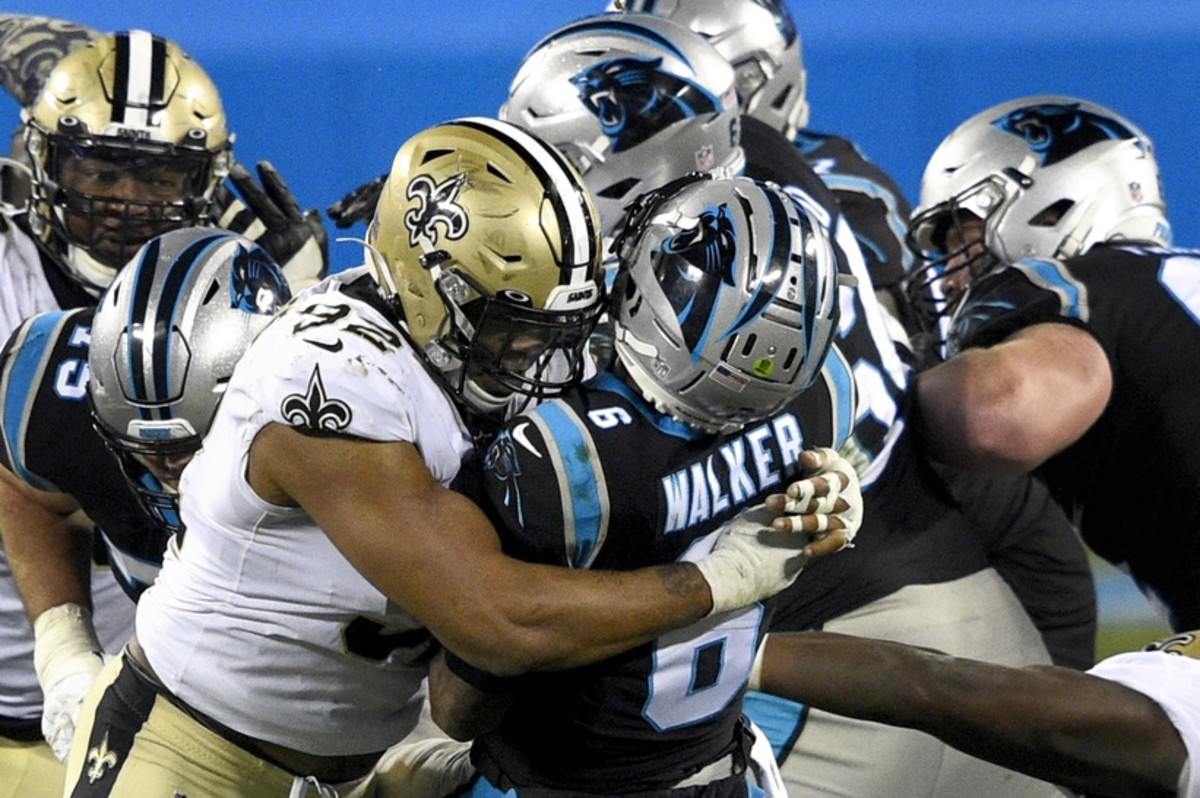 Jan 3, 2021; Carolina Panthers quarterback P.J. Walker (6) throws an interception as he is hit by New Orleans Saints defensive end Marcus Davenport (92). Mandatory Credit: Bob Donnan-USA TODAY Sports