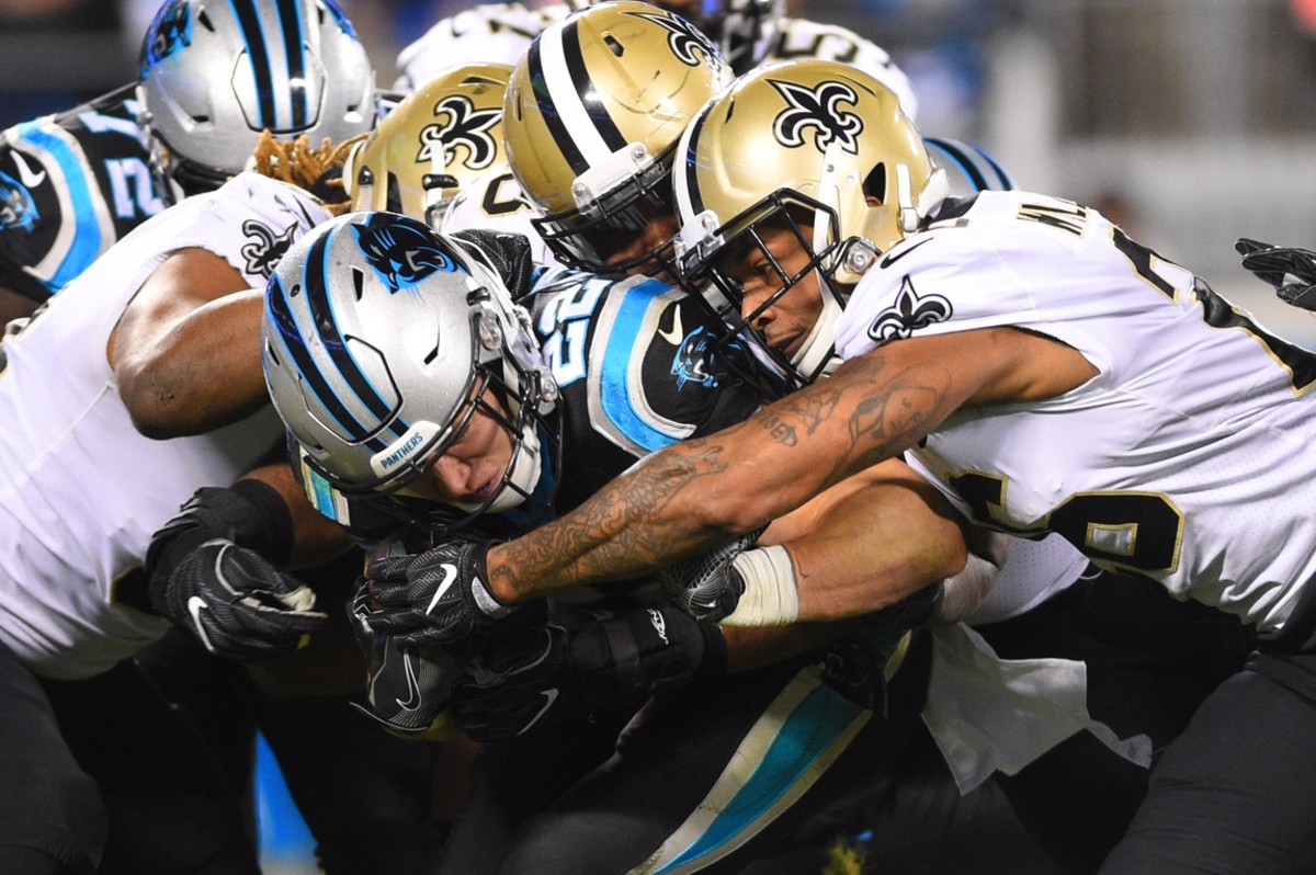 Carolina Panthers running back Christian McCaffrey (22) is tackled by the New Orleans Saints. Mandatory Credit: Bob Donnan-USA TODAY Sports