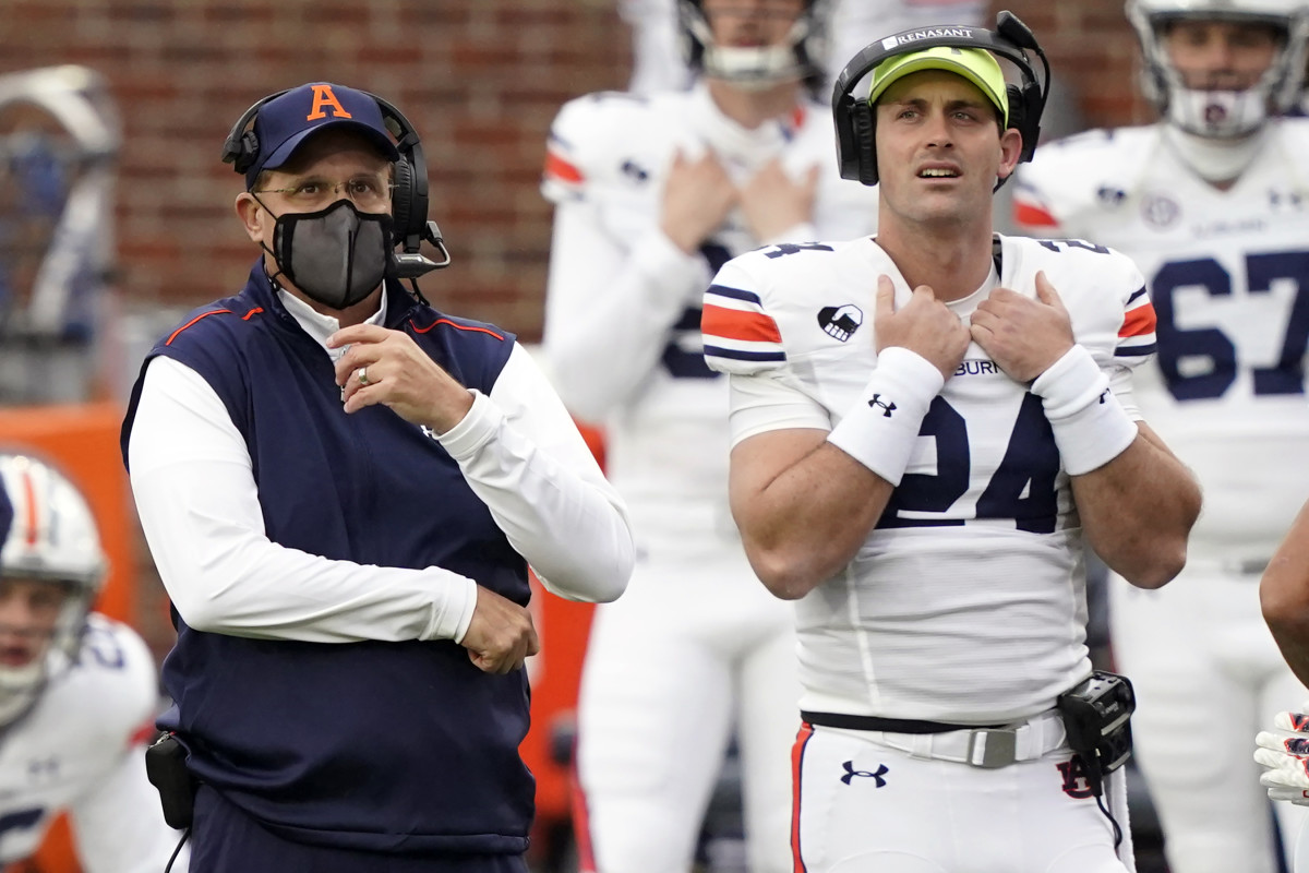 Auburn head coach Gus Malzahn, left, and Auburn quarterback Cord Sandberg (24) look at the scoreboard during the first half of an NCAA college football game against Mississippi in Oxford, Miss., Saturday Oct. 24, 2020. (AP Photo/Rogelio V. Solis)