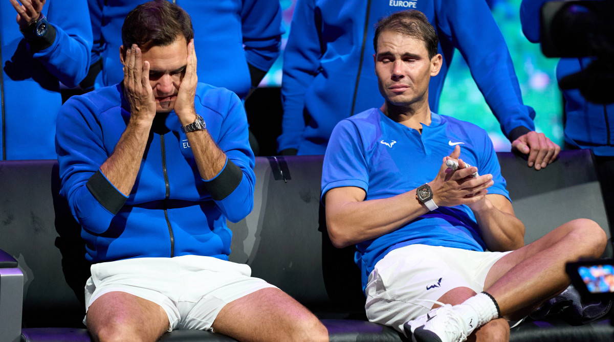 A tearful Roger Federer and Rafael Nadal look on after Federer’s last tennis match.