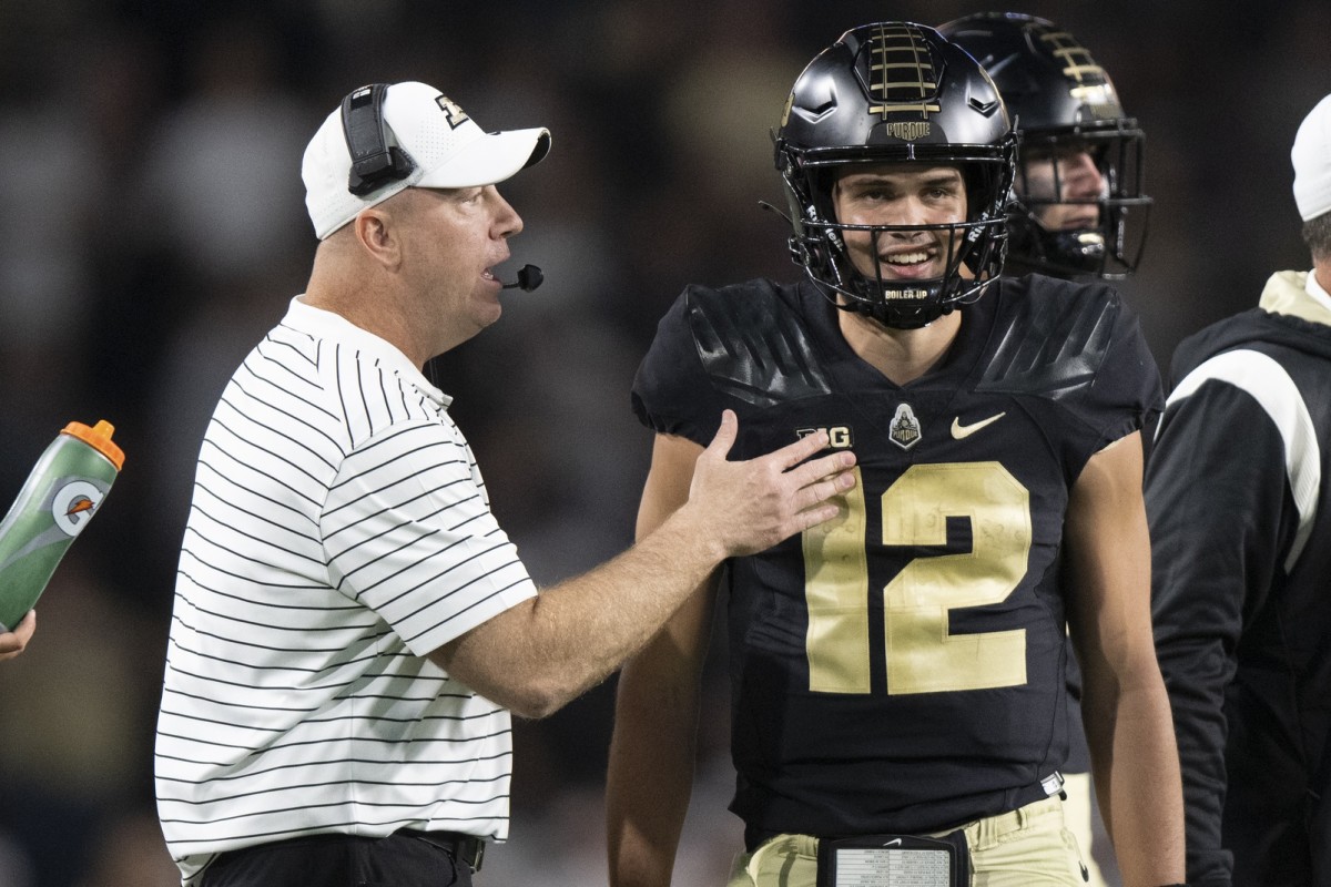 Sep 24, 2022; West Lafayette, Indiana, USA; Purdue Boilermakers quarterback Austin Burton (12) talks with Purdue Boilermakers head coach Jeff Brohm during the fourth quarter at Ross-Ade Stadium. 
