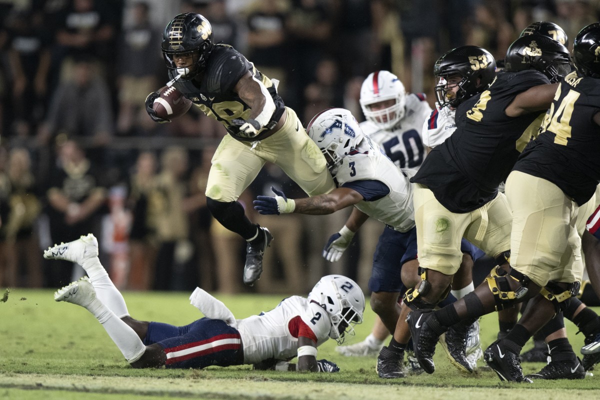 Sep 24, 2022; West Lafayette, Indiana, USA; Purdue Boilermakers running back Dylan Downing (38) jumps over Florida Atlantic Owls cornerback Romain Mungin (2) during the second half at Ross-Ade Stadium. 