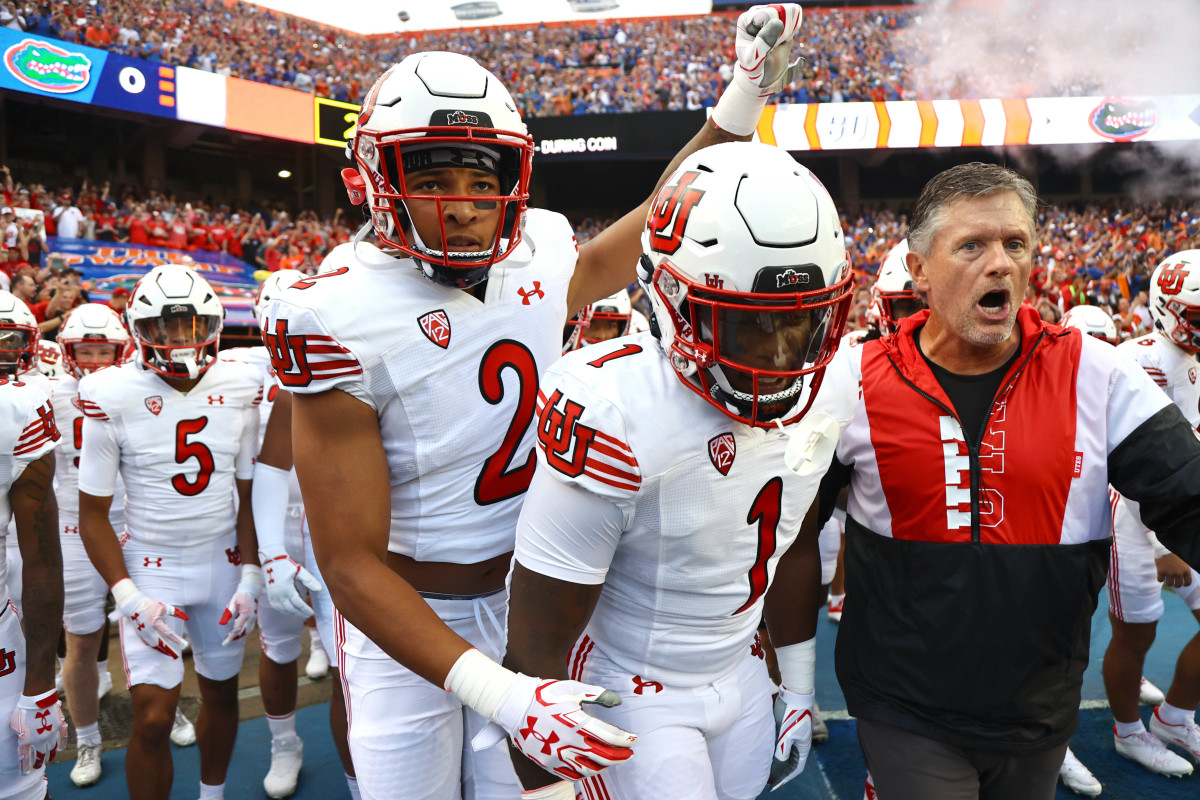 Utah Utes head coach Kyle Whittingham and teammates runs onto the field prior to the game against the Florida Gators at Steve Spurrier-Florida Field.